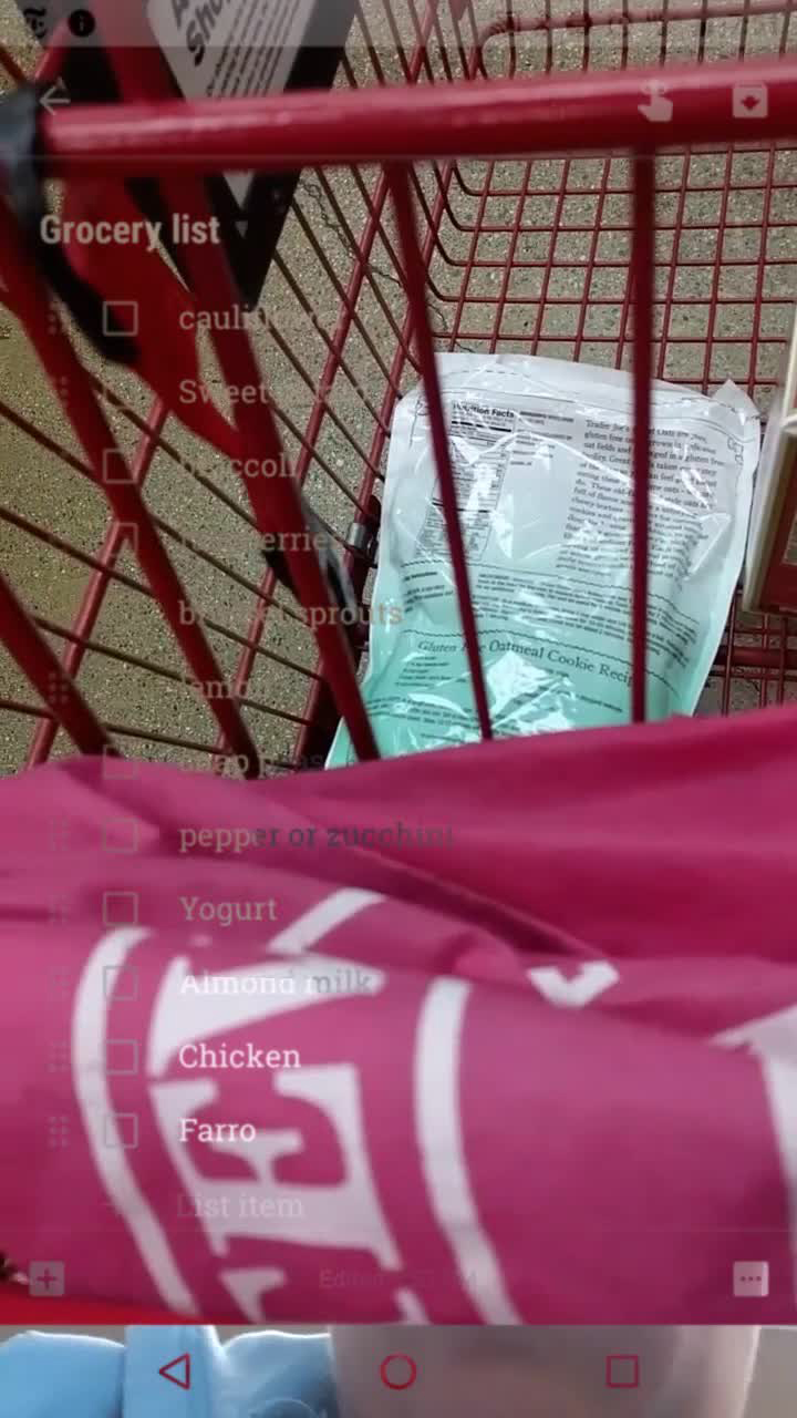 User's digital grocery list items overlaid on the contents of their red shopping cart at the store, in still frame from user_is_present
