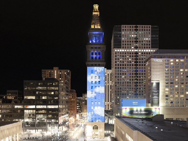 Computer generated clouds on a bright blue sky projected on to the Denver Clock Tower.