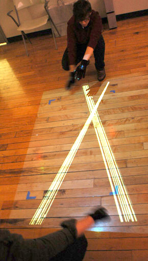 One user crosses their arms, creating an x-shape between the two users in tangle